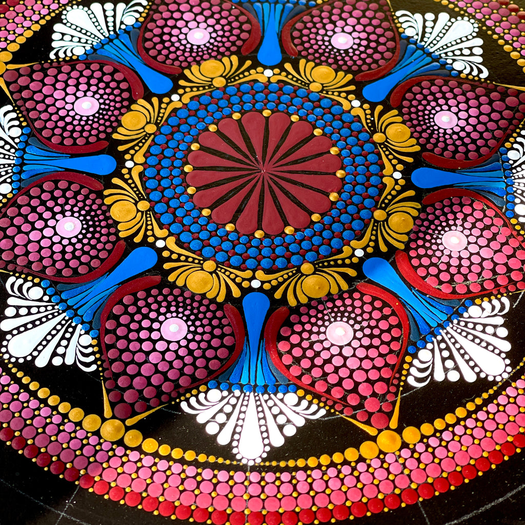 Colorful mandala with intricate mandala patterns on a black background