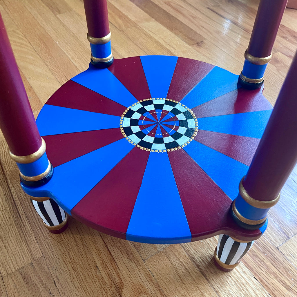 Colorful wooden chair with a geometric design on a wooden floor blue, red and white, checkers